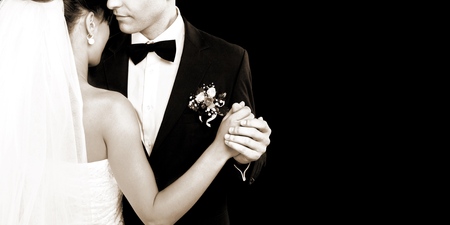 Happy just married young couple on black background, vintageの写真素材