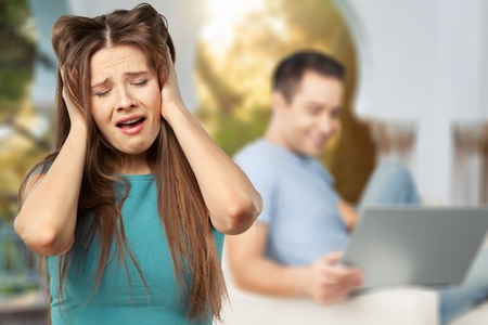 Serious sad woman thinking over a problem, man sitting aside, end of long-term relations, an...