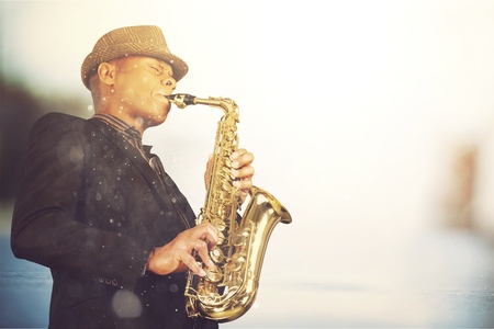 Closeup hands of man playing golden alto saxophoneの写真素材