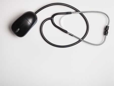 Stethoscope with computer mouse on white backgroundの写真素材