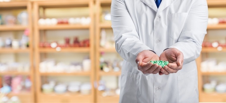 Man doctor hand holding pillの写真素材