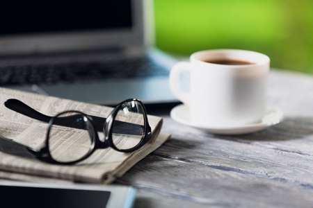 Newspaper with tablet on tableの写真素材