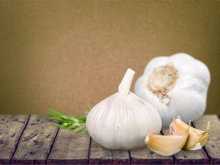 Garlic. Garlic Cloves and Garlic Bulb in vintage wooden bowl.の写真素材