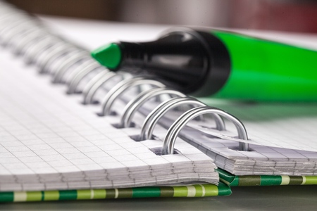 Green marker with notebookの写真素材