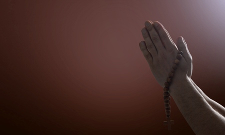 Silhouette rosary against cross in hand. Background sunriseの写真素材