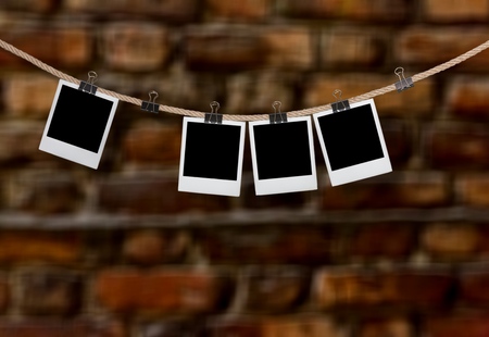blank instant photos hanging on the clothesline