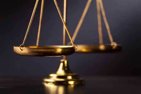 Scale of justice on a black backgroundの写真素材