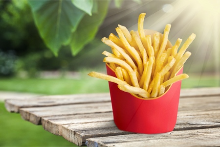 French fries in a red carton box isolated on whiteの写真素材