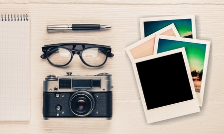 Summer photo album of journey honeymoon trip on wood table. instant photo of vintage camera - vintage and retro styleの写真素材