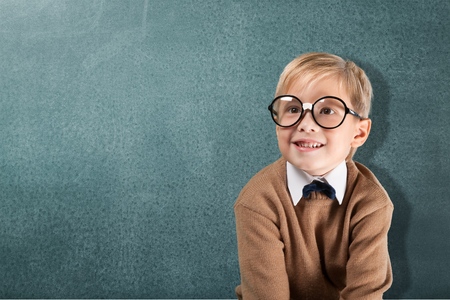 Cheerful smiling boy on a green background.の写真素材