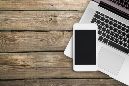 Phone and laptop on deskの写真素材