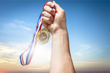 Businessman hand holding golden medalの写真素材