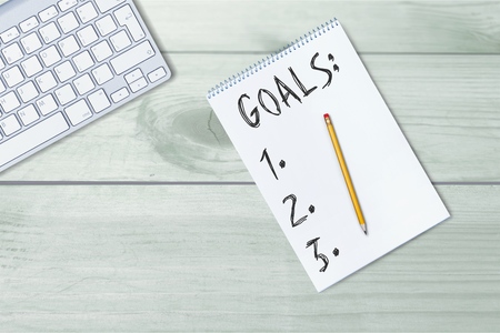 Top view 2017 goals list with notebook, cup of coffee on wooden deskの写真素材