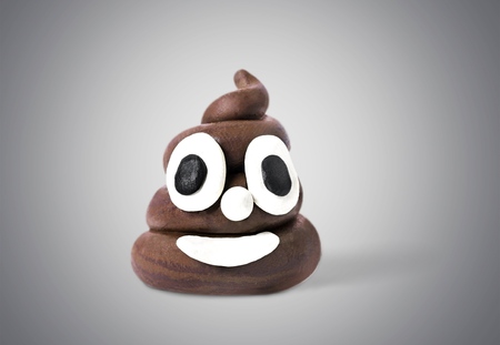 Poop emoticon on bright background. Minimal concept.