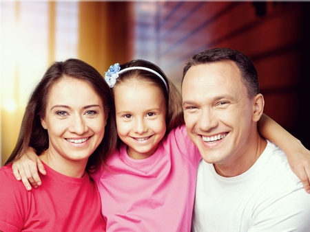 happy family. Mother and baby daughter plays, hugging, kissing at home on the sofaの写真素材
