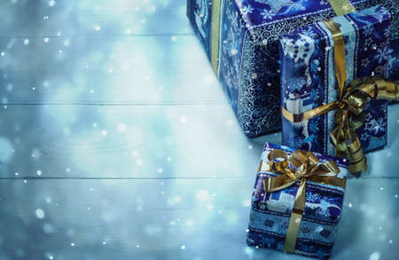 Present boxes on blue background greeting card holidays concept.