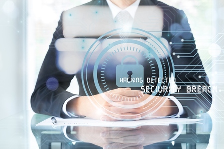 Businessman on blurred background using antivirus to