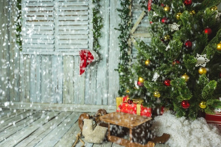 Christmas tree with Sleigh and gifts in roomの写真素材