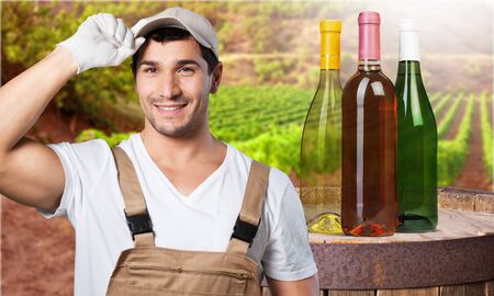 Happy young gardener in dungarees. Isolated on whiteの写真素材
