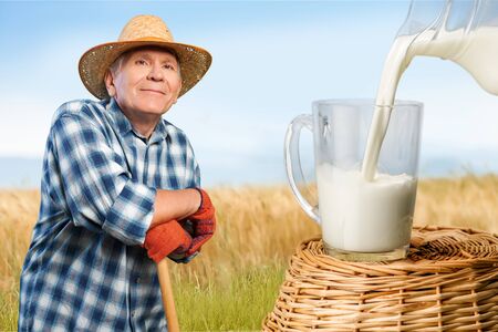 Pouring a glass of milkの写真素材