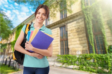 Beautiful student girl with backpack and books, isolated on white background