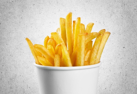 french fries in a paper wrapper on white background