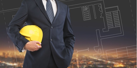engineer yellow helmet for workers security on the background of a new high-rise apartment buildings...