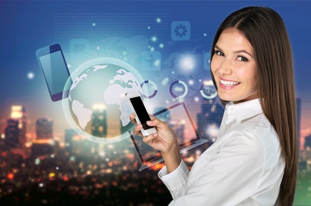 Closeup of young  happy woman with mobile phone, over white background