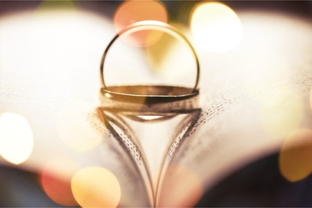 Wedding rings inter placed to create two heart shaped shadows (a unique placement)の写真素材