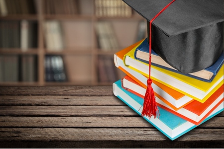 Graduation cap on stack of booksの写真素材