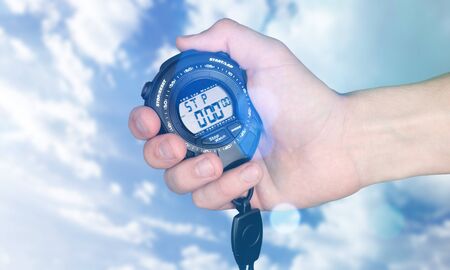 Hand holding stopwatch