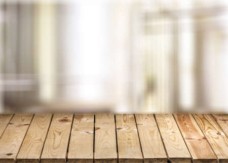 Wood table top on white blurred abstract background from building hallway  - can be used for display or montage your productsの写真素材