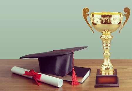 Graduation cap with champion trophyの写真素材