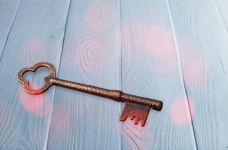 Antique key on old wooden desk