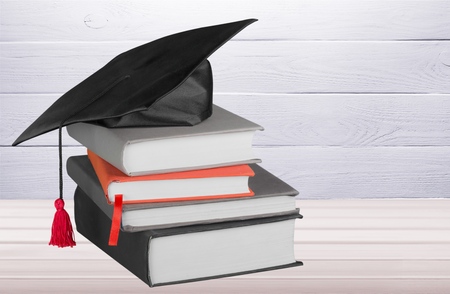 Graduation mortar on top of booksの写真素材