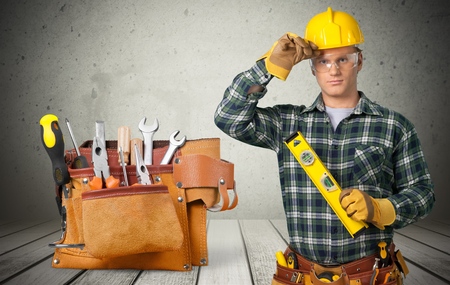 Carpenter Contractor Man Wearing Gogles Toolbelt Hardhat Isolated on Whiteの写真素材