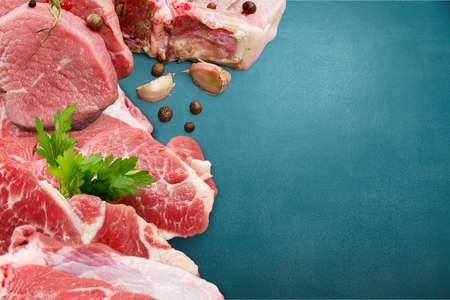 Fresh Raw Beef steak Mignon, with salt, peppercorns, thyme, tomatoes.の写真素材