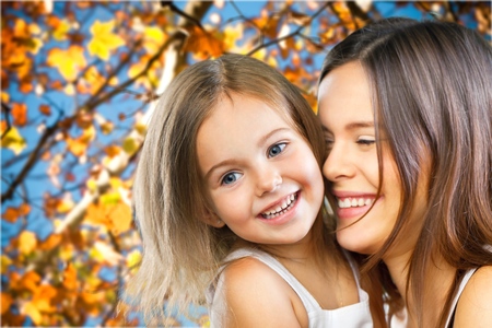 Mother and Baby kissing and hugging at Home. Happy Smiling Family Portrait. Mom and Her Child Having Fun togetherの写真素材