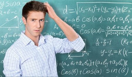 Confusion - Young man scratching his head on white