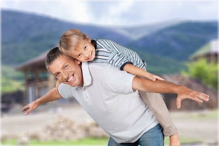 Man and young boy playing outdoorsの写真素材