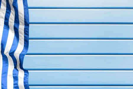 Blank rustic teal blue wood beach sign with pink and white striped beach towel borderの写真素材