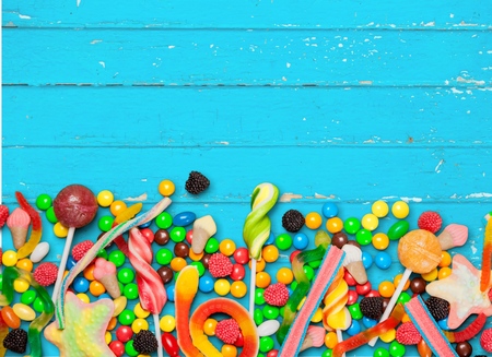 variety of candies on a wooden background