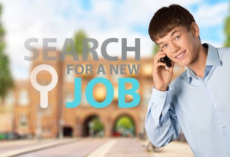 Handsome Young Man Talking on a Cell Phone White Isolatedの写真素材