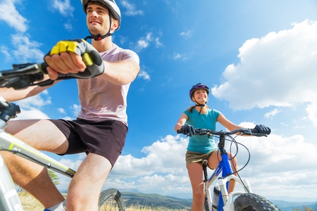 Happy Carefree Couple Cycling at the Mountains