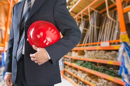 Cropped view of engineer holding helmet on white background with clipping pathの写真素材