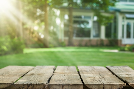 Empty of wood table top on blur of fresh green abstract from garden with sunlight .For montage product display or design key visual layoutの写真素材