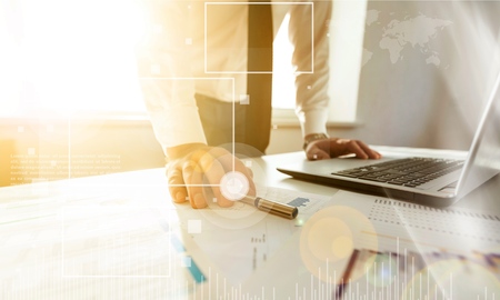 Double exposure of businessman hand working with new modern computer and business strategy as...