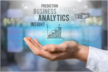 businessman touching analytics symbol on black background