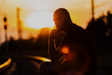 Young man on street at sunsetの写真素材
