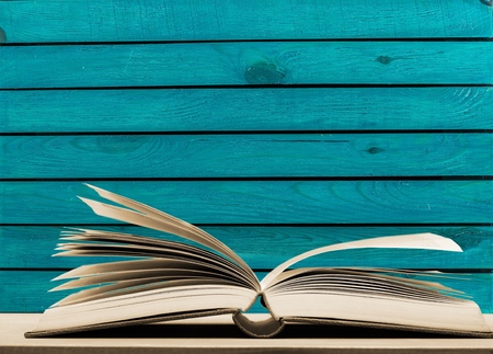 Open book on old wooden table.の写真素材